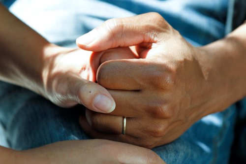 Two people holding hands