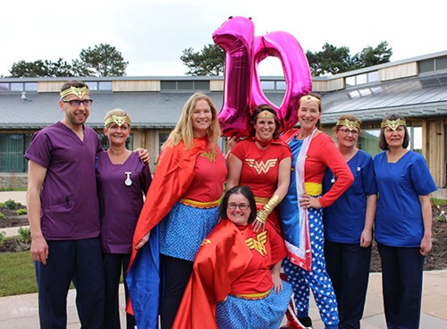 Hospice superheros with staff