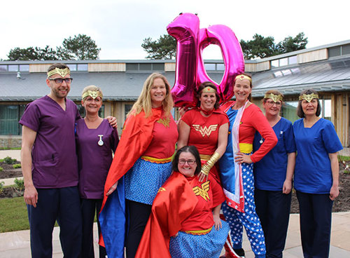 Hospice superheros with staff