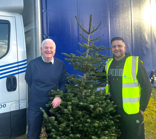 Volunteers Ron and Mark collect Christmas trees for recycling.